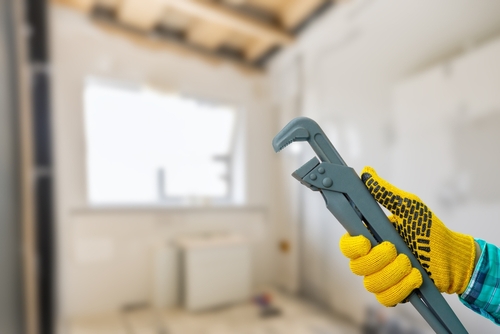 The,concept,of,plumbing,services.,a,craftsman's,hand,shows,an